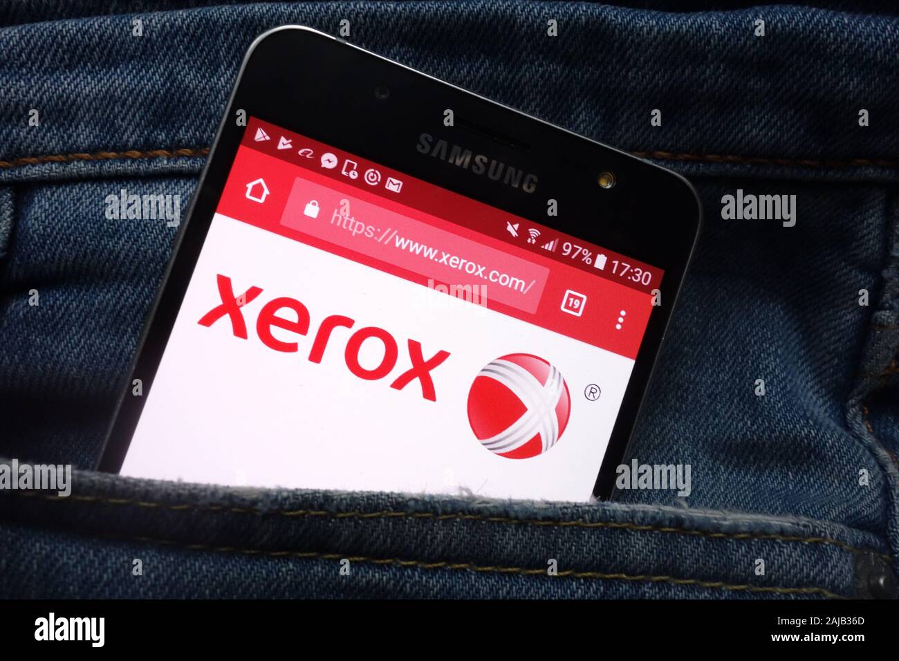 Xerox website displayed on Samsung smartphone hidden in jeans pocket Stock Photo