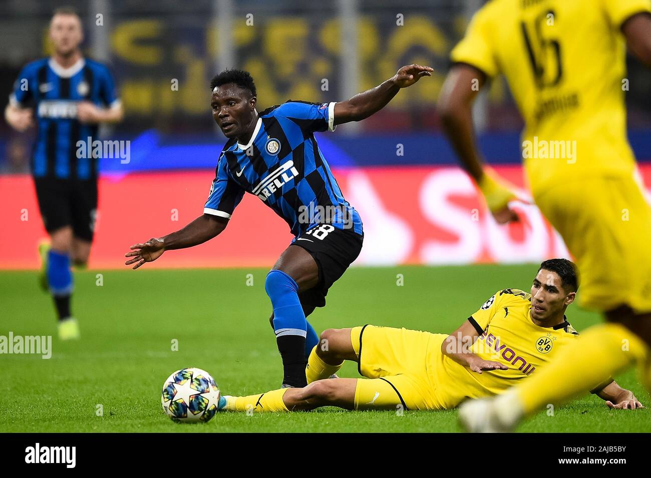 Milan, Italy - 23 October, 2019: Kwadwo Asamoah (C) of FC Internazionale is tackled by Achraf Hakimi of Borussia Dortmund during the UEFA Champions League football match between FC Internazionale and Borussia Dortmund. FC Internazionale won 2-0 over Borussia Dortmund. Credit: Nicolò Campo/Alamy Live News Stock Photo