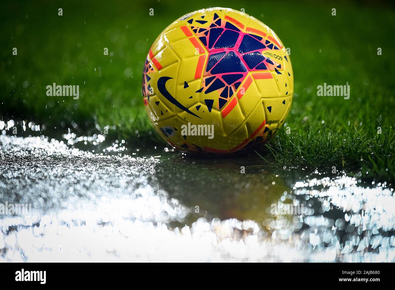 Turin, Italy - 23 November, 2019: Official match ball Nike Merlin Hi-Vis is  pictured near a puddle during the Serie A football match between Torino FC  and FC Internazionale. FC Internazionale won