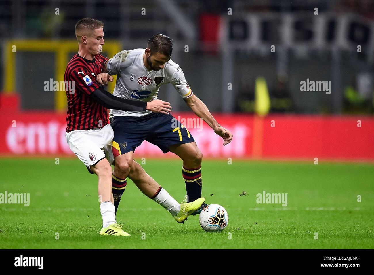 Milan, Italy - 20 October, 2019: Panagiotis Tachtsidis of US Lecce competes for the ball with Andrea Conti of AC Milan during the Serie A football match between AC Milan and US Lecce. The match ended in a 2-2 tie. Credit: Nicolò Campo/Alamy Live News Stock Photo