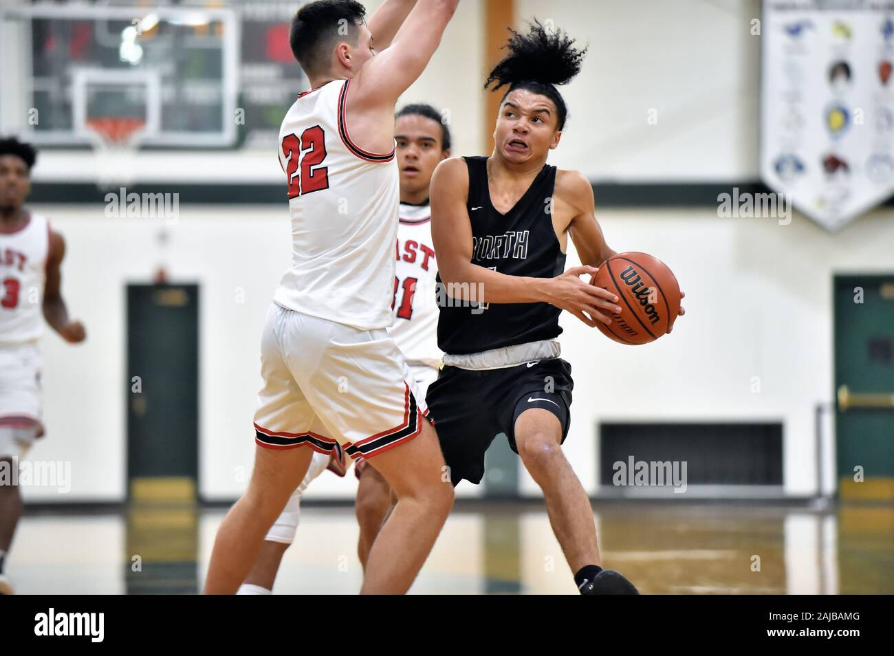 Player striving to drive around the close defense of an opponent. USA. Stock Photo