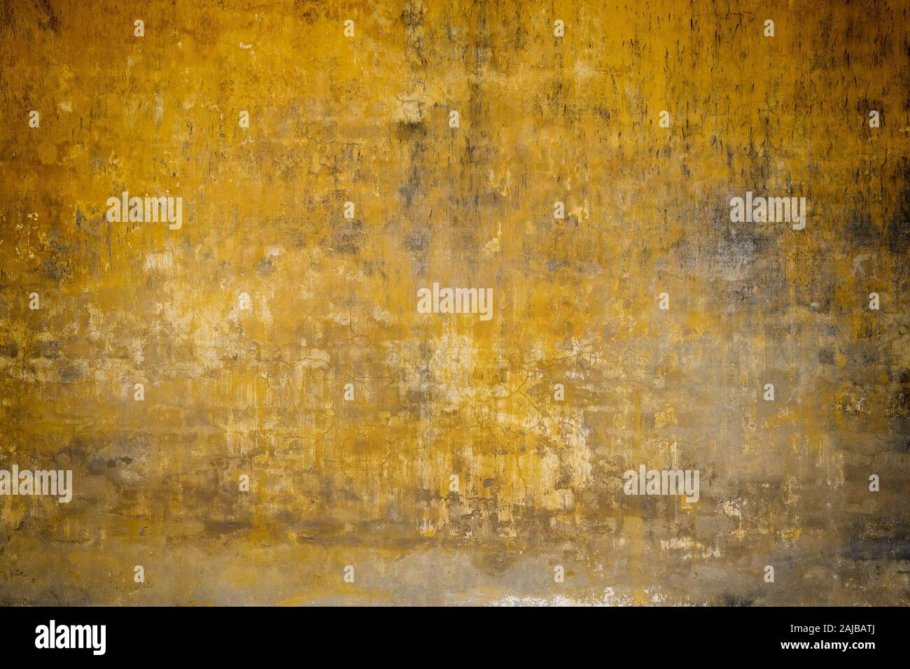 Real wall background, grungy yellow texture. Stock Photo