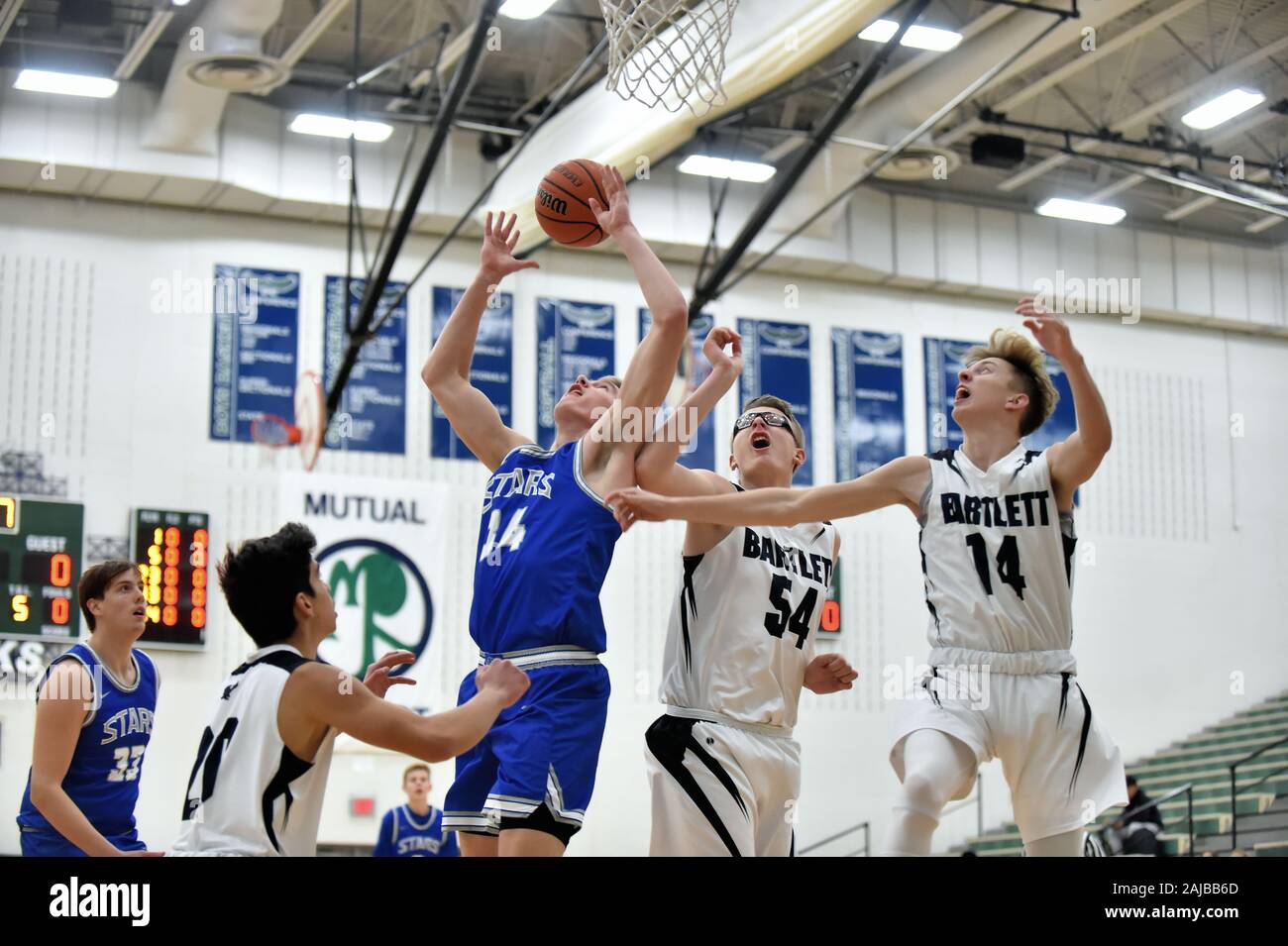 Players elevated in competition for a rebound. USA. Stock Photo