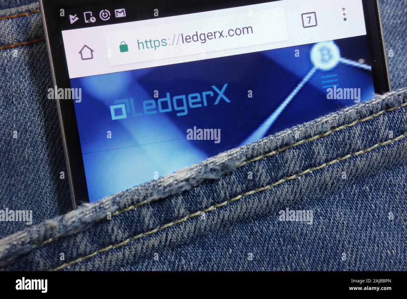 LedgerX website displayed on smartphone hidden in jeans pocket Stock Photo