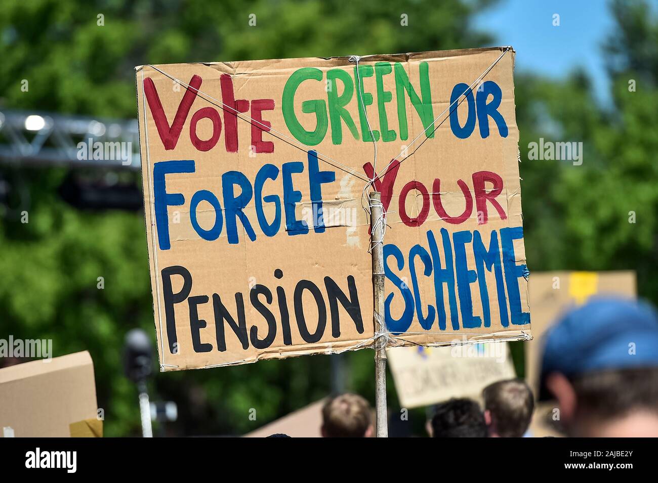 Lausanne, Switzerland - 09 August, 2019: A sign reading 'Vote green or forget your pension scheme' is holded by a climate activist during a Fridays For Future strike for climate protection that is part of 'SMILE for Future' event. More than 450 young climate activists from different European countries gathered to attend the summit 'SMILE for Future', that stands for Summer Meeting in Lausanne Europe. The aim of the summit is to reinforce the links between the participants of the European Youth Climate Strike movement and to define the future of the mobilisation against climate change. Credit: Stock Photo