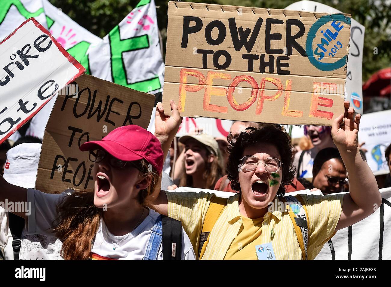 Lausanne, Switzerland - 09 August, 2019: A climate activist holds a sign reading 'Power to the people' during a Fridays For Future strike for climate protection that is part of 'SMILE for Future' event. More than 450 young climate activists from different European countries gathered to attend the summit 'SMILE for Future', that stands for Summer Meeting in Lausanne Europe. The aim of the summit is to reinforce the links between the participants of the European Youth Climate Strike movement and to define the future of the mobilisation against climate change. Credit: Nicolò Campo/Alamy Live News Stock Photo