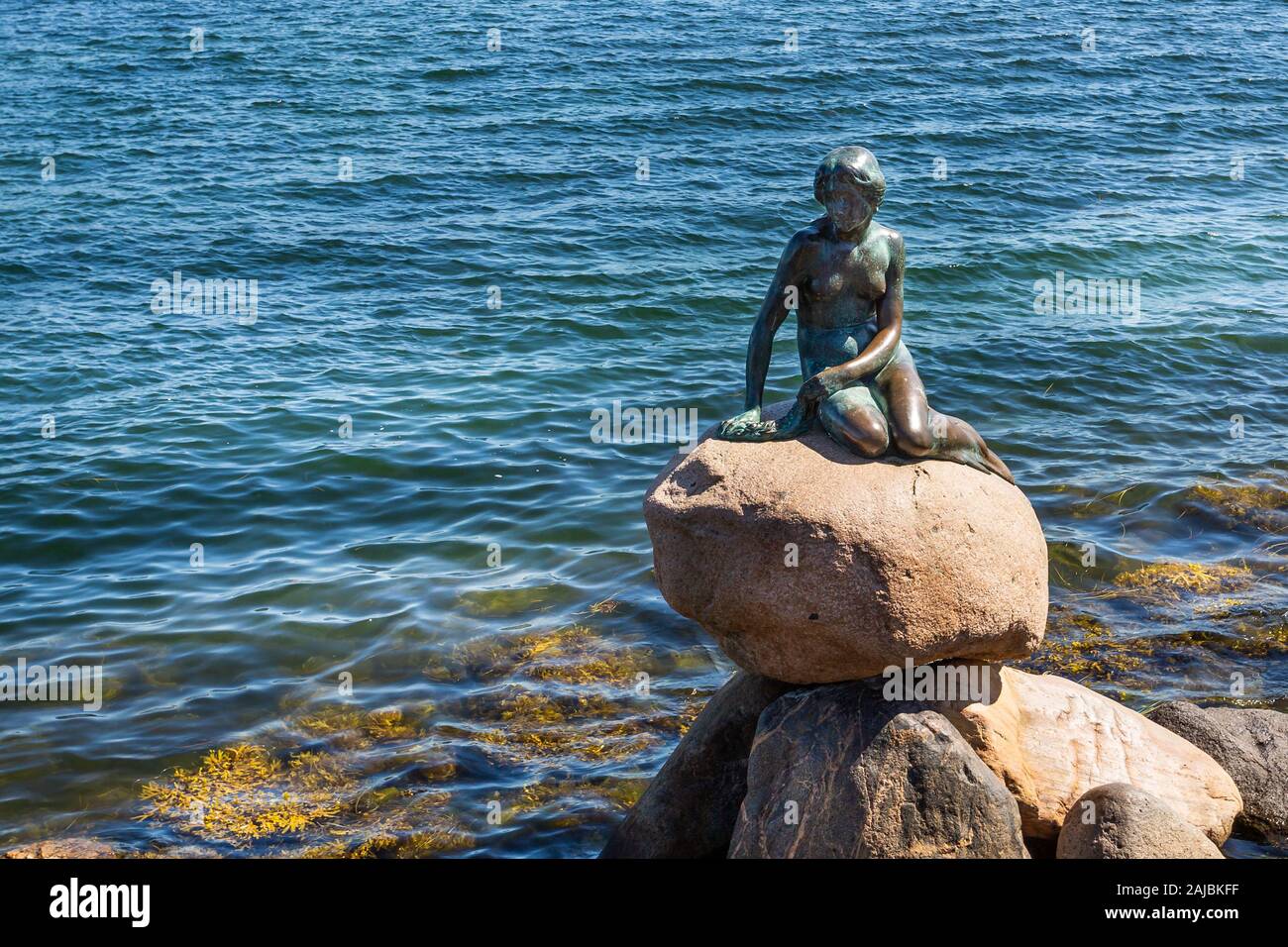 Famous bronze statue of The Little Mermaid at the waterside at the Langelinie promenade in Copenhagen, Denmark on 18 July 2019 Stock Photo