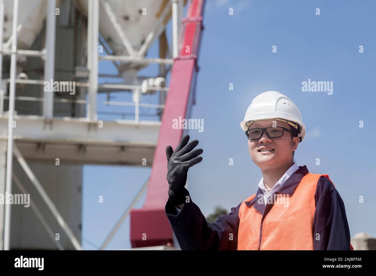 concrete worker waving with arm Stock Photo Alamy