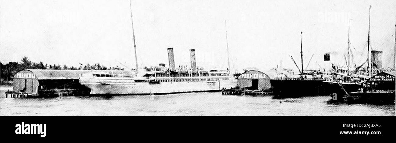 Panama and the canal . Manzanillo Lighthouse Rising Above Them. once, a very tall man, standing on the shouklcrs of anotherequally tall, could scarcely raise the top of his head to thesurface. 46 APPROACH TO THE ISTHMUS Colon If it be the dry season, the approach to the Isthmus bysteamer is not without beauty. Great masses of whiteclouds drift lazily over the low green hills thatrise one above another from the sea-coast. Hereand there bold headlands and deep bays can be seen,and many small islands seem almost to float like ships uponthe blue waters of the Caribbean. Off in the distance is them Stock Photo