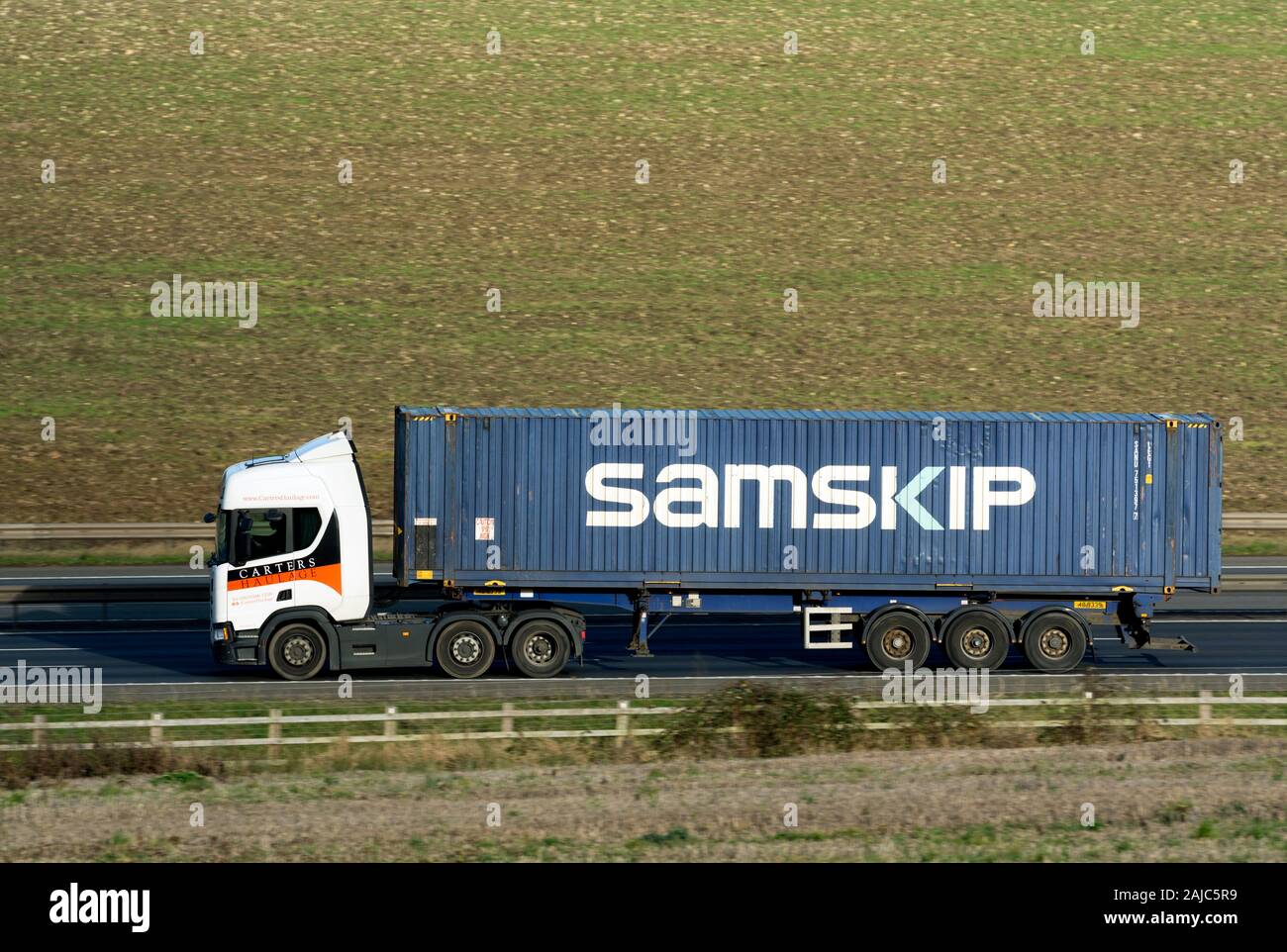 Carters Haulage lorry with a Samskip container on the M40 motorway, Warwickshire, UK Stock Photo