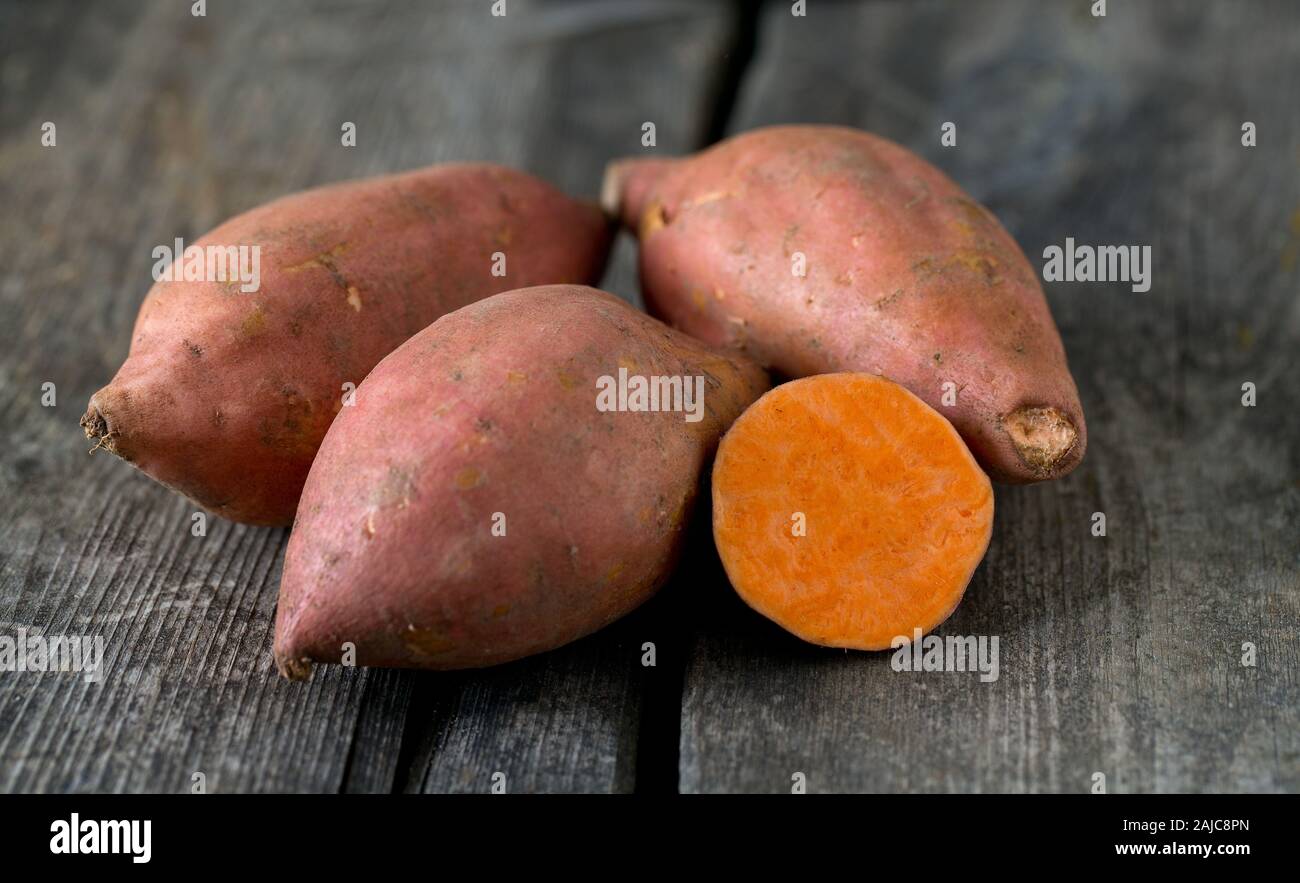 sweet poato on wooden surface Stock Photo