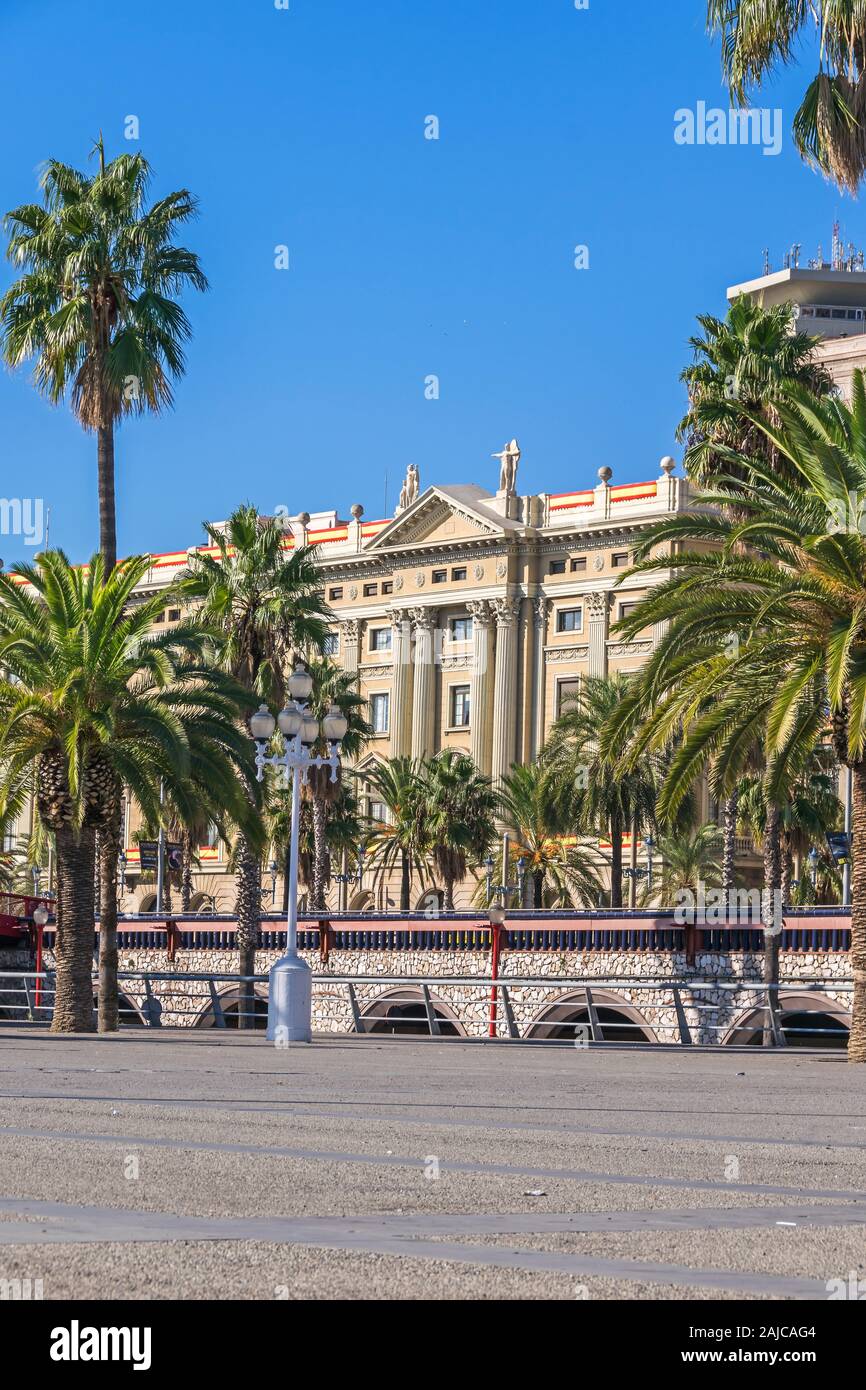 Barcelona, Spain - November 2, 2019: Avenue Passeig de Colom lined with palm trees with the building of the Captaincy General  (Spanish: palacio de la Stock Photo
