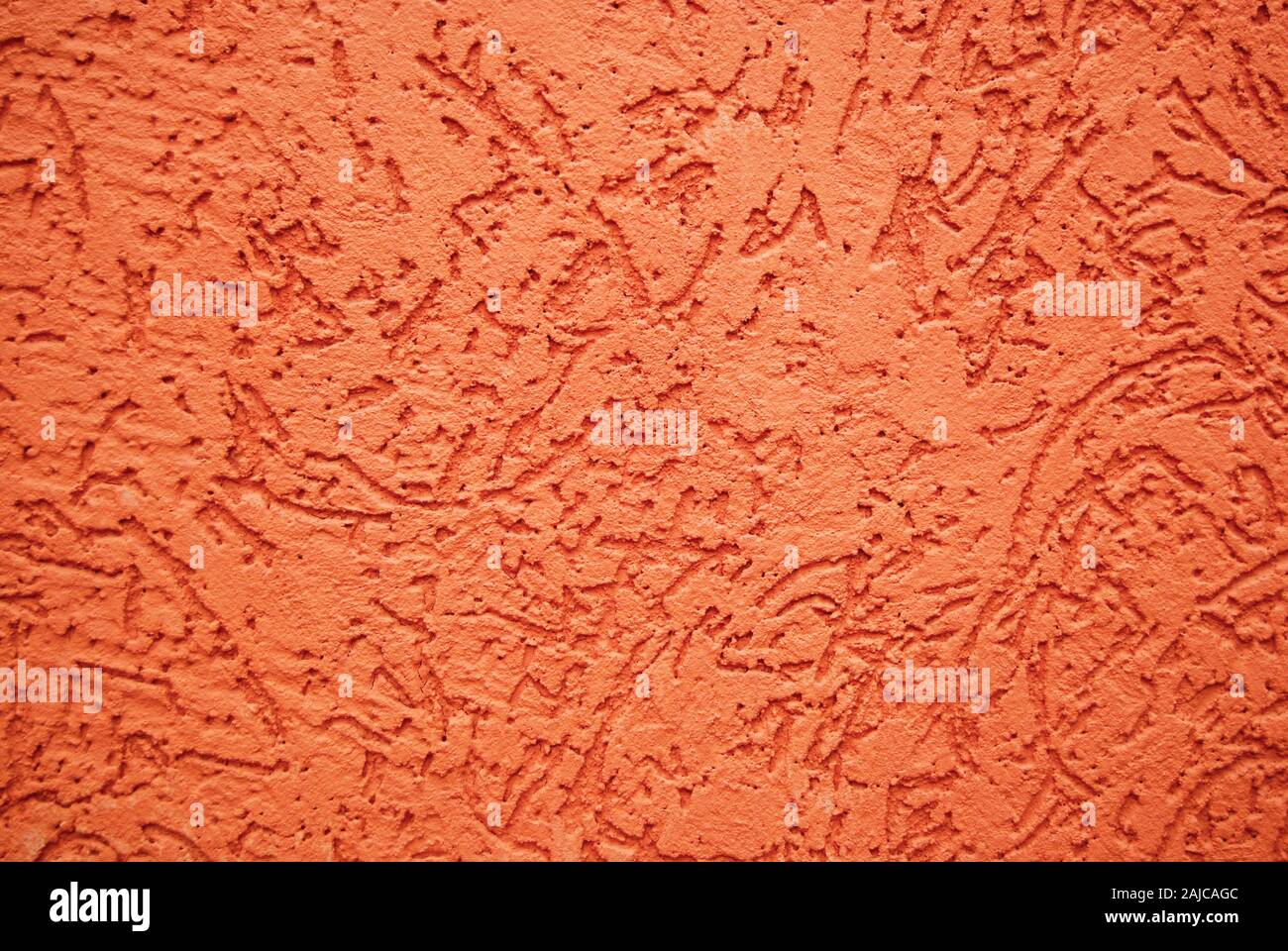 Reddish orange textured background of painted stone wall Stock Photo
