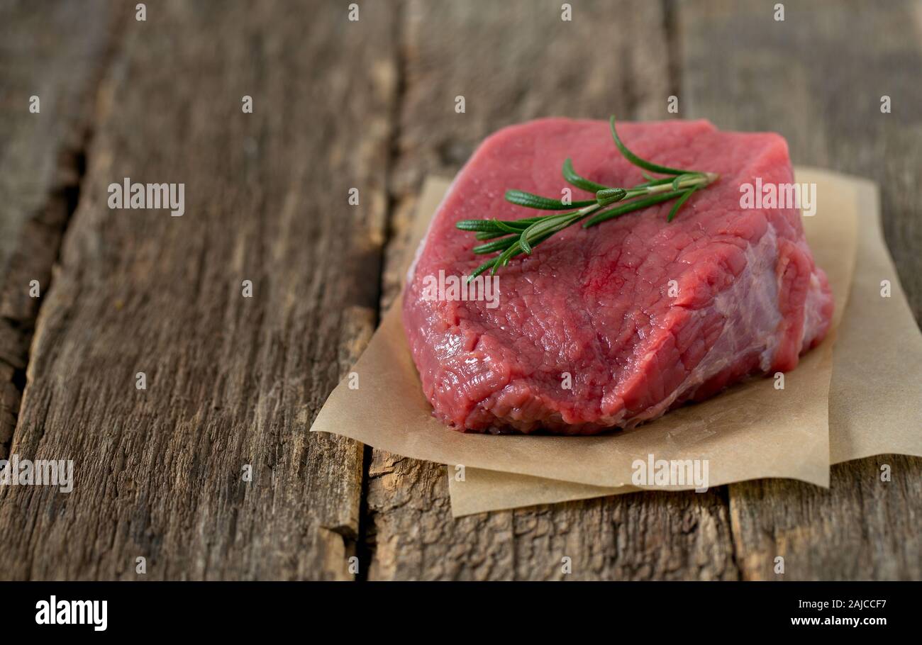 raw steak on wooden surface Stock Photo