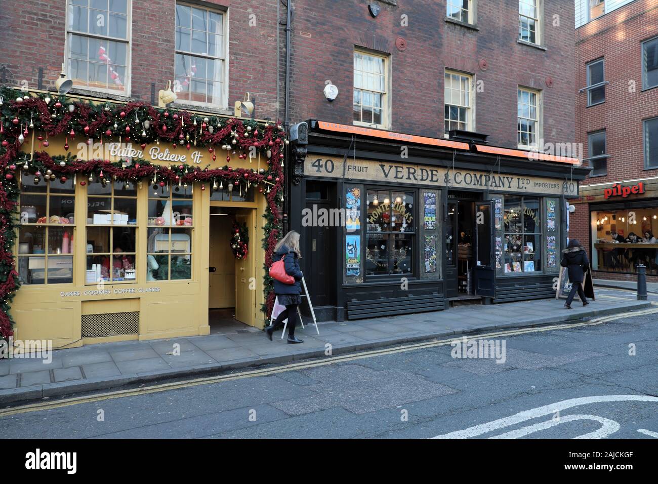 Butter Believe It bakery & Verde & Company shopfront with Christmas decorations in Spitalfields East London E1 England UK  KATHY DEWITT Stock Photo