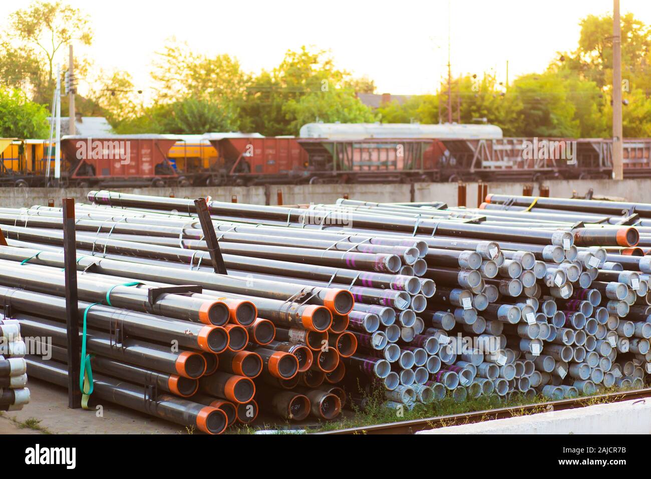 Metal rolling. Pipes folded in a railway warehouse are being prepared for shipment. The concept of metalworking and heavy industry. Stock Photo