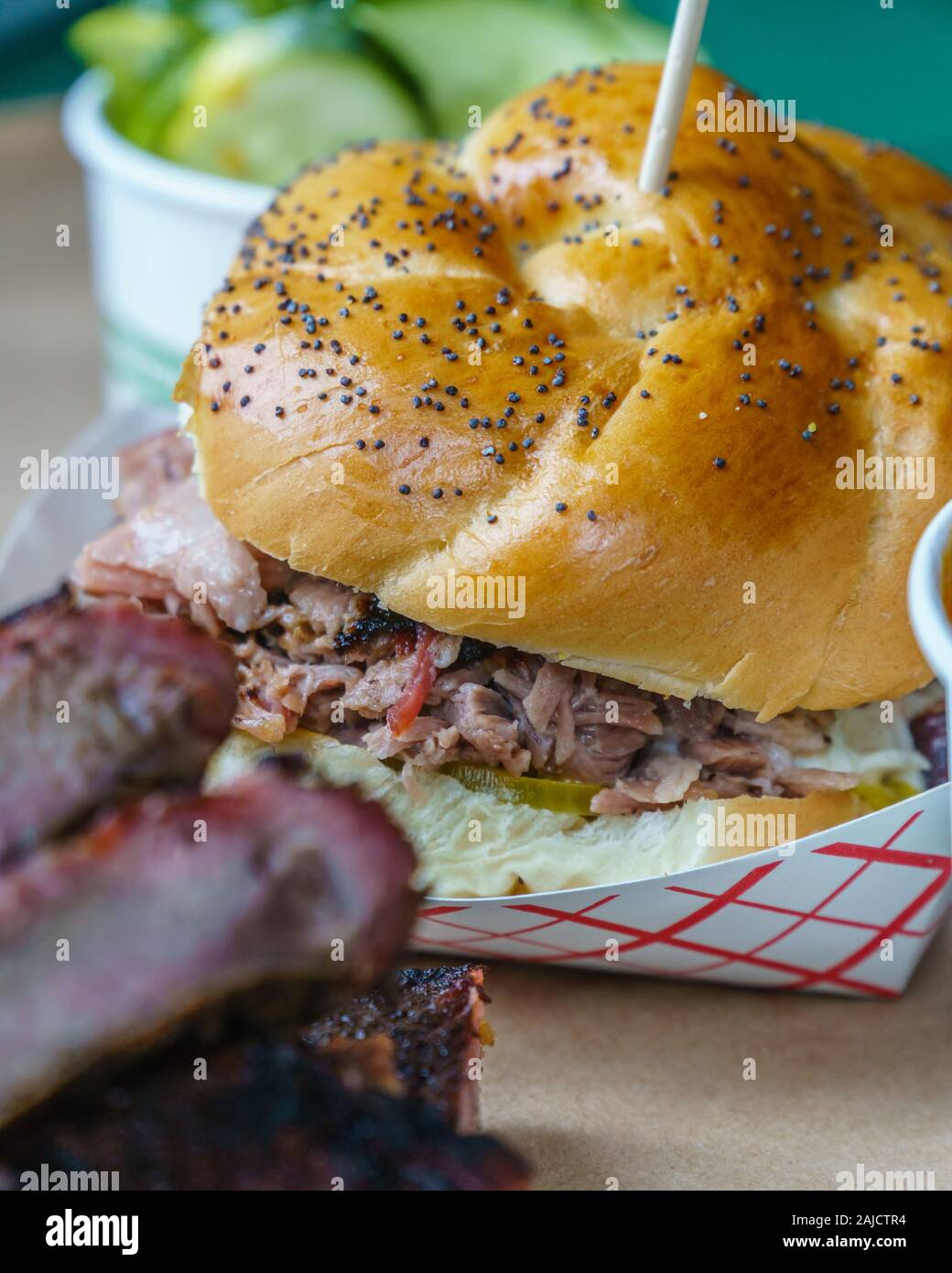 Close-up view of southern U.S. barbecue meal including ribs, pulled pork sandwich and barbecue beans. Stock Photo