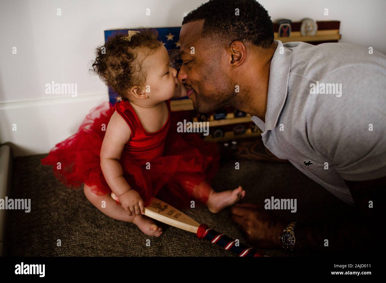 African American Dad Rubbing Noses with Biracial Daughter Stock Photo