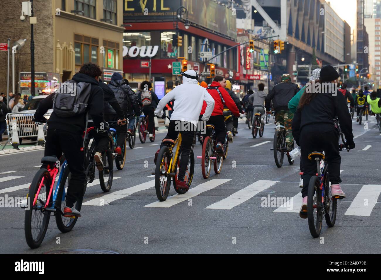 A 'wheelie crew' of young people of color riding bikes en masse in New York City (December 31, 2019) Stock Photo