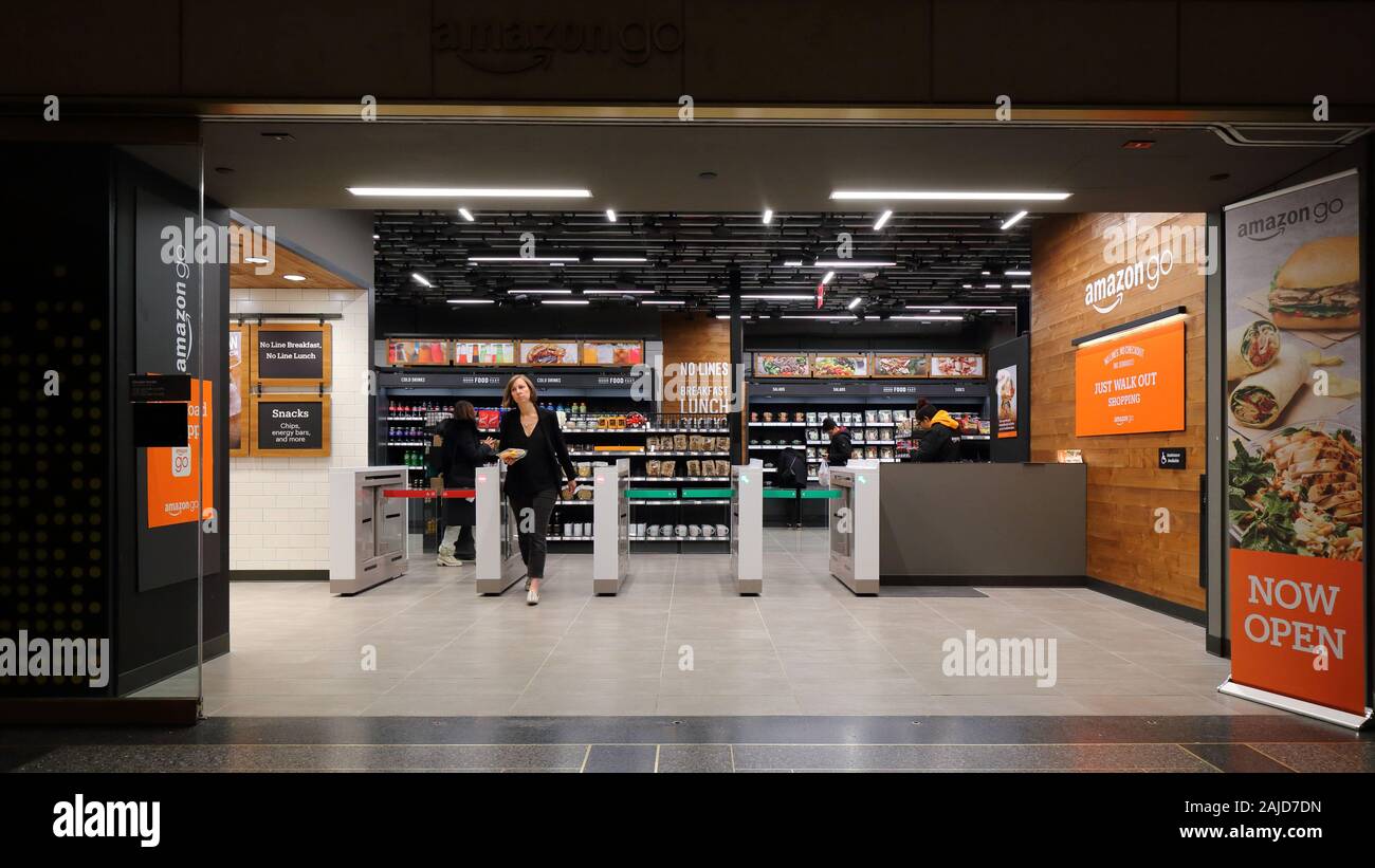 A woman exits an Amazon Go store inside Rockefeller Center in Manhattan, New York, NY. Amazon go stores are cashier-less, cash-free convenience stores Stock Photo