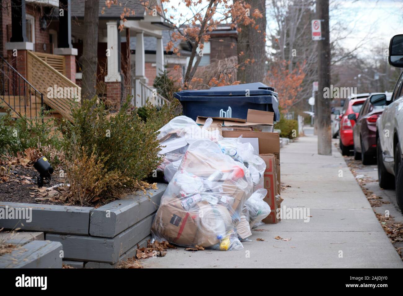 Additional bags of recycling waste, next to Toronto city recycling bin