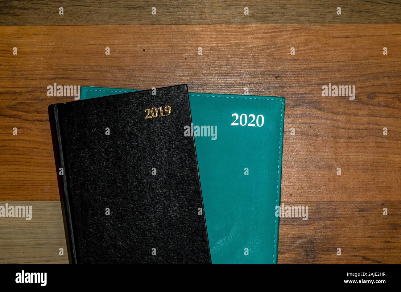 2019 and 2020 diaries isolated on a wooden background image with copy space Stock Photo