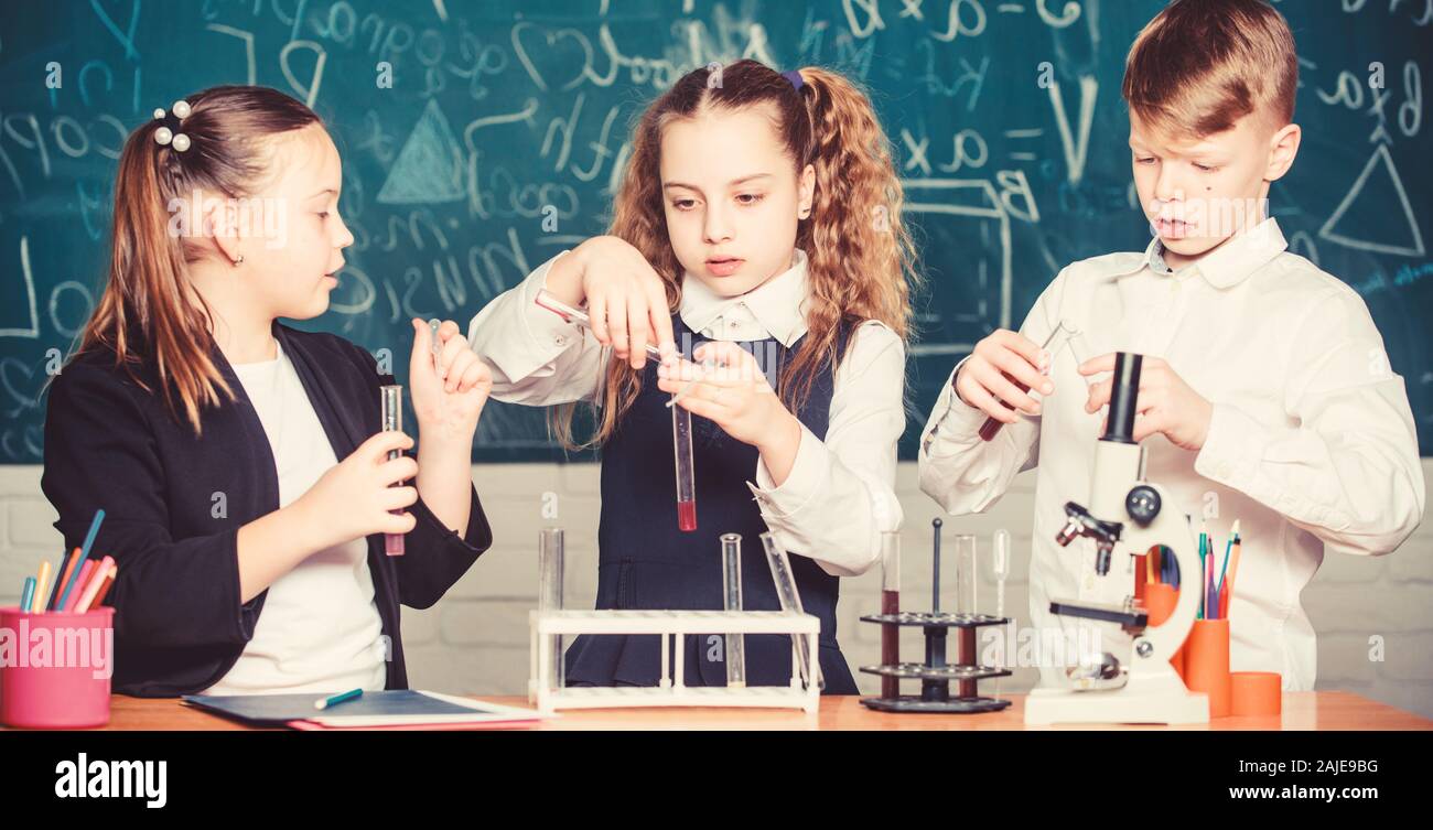 students doing experiments with microscope. Happy children. Chemistry