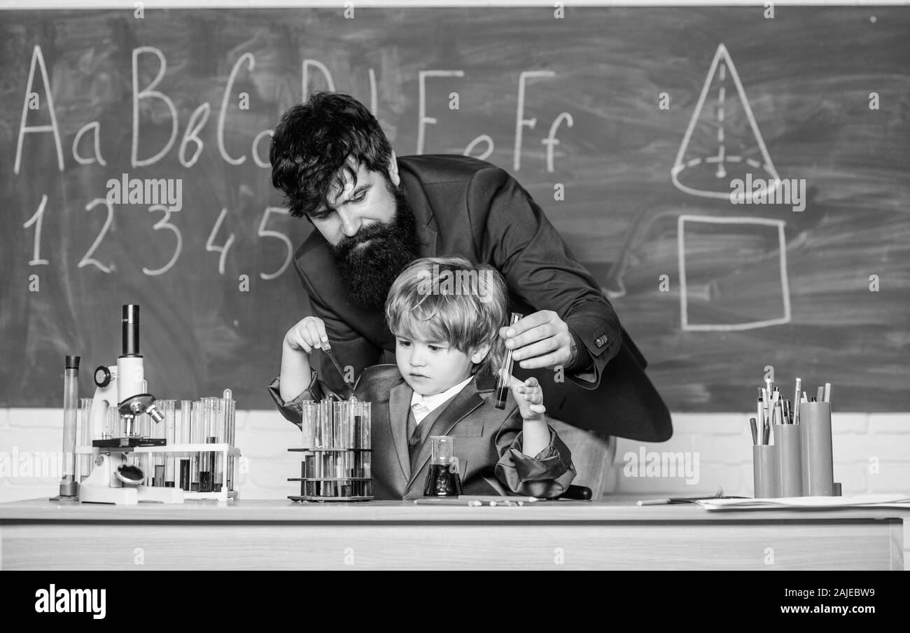 Basic Upbringing Teacher and child school classroom. Chemistry lesson. Lab experiment ...