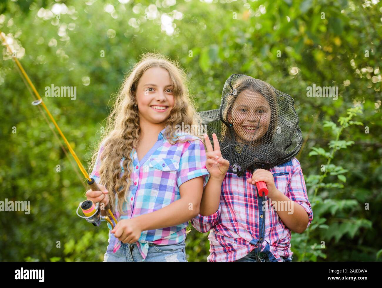 Having fun. Fly fishing. Kids spend time together fishing. Fishing skills.  Adorable girls nature background. Teamwork. Summer hobby. Happy smiling  children with net and rod. Happy childhood Stock Photo - Alamy