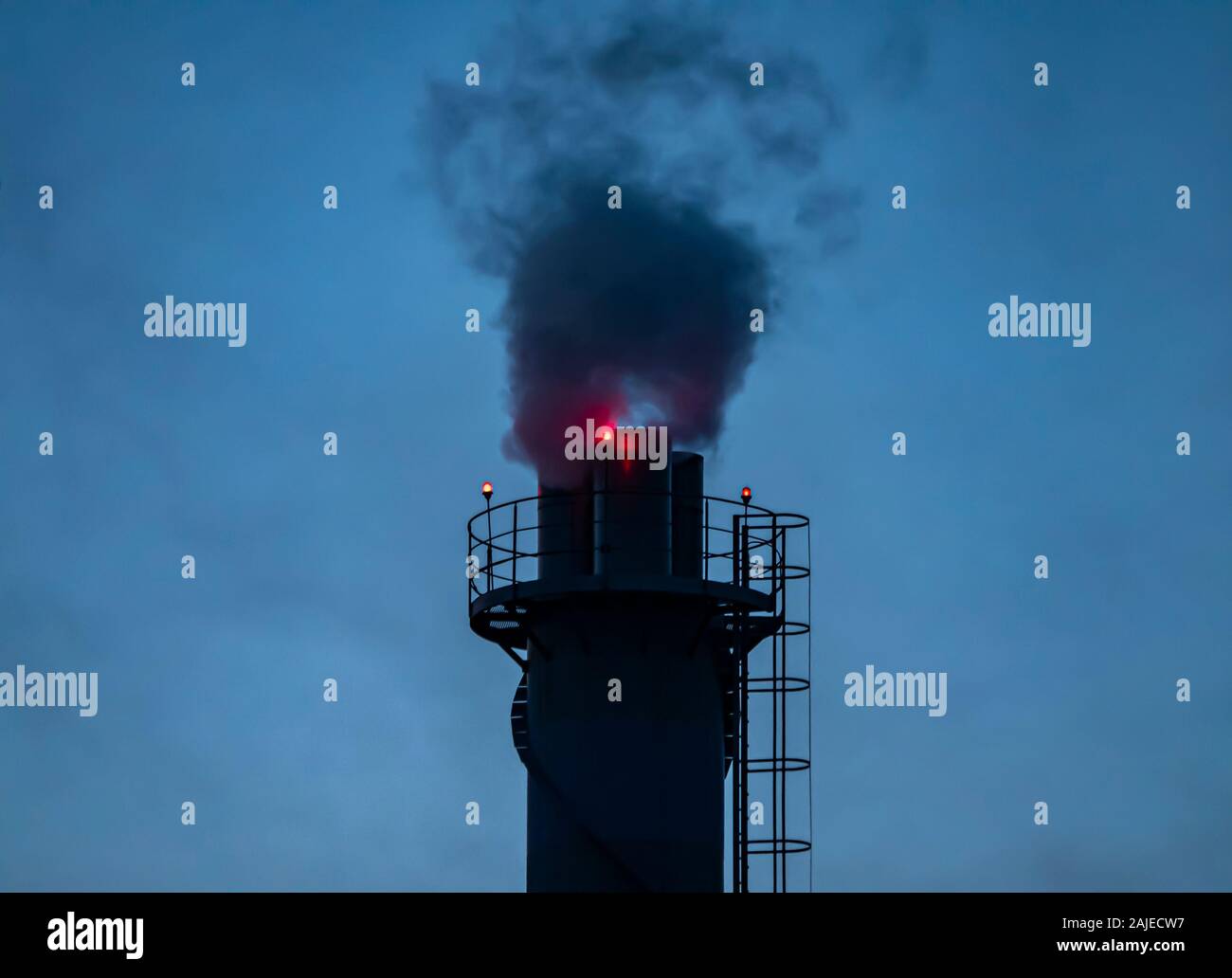 The smoking chimney of an enterprise at night. Technology. Place for