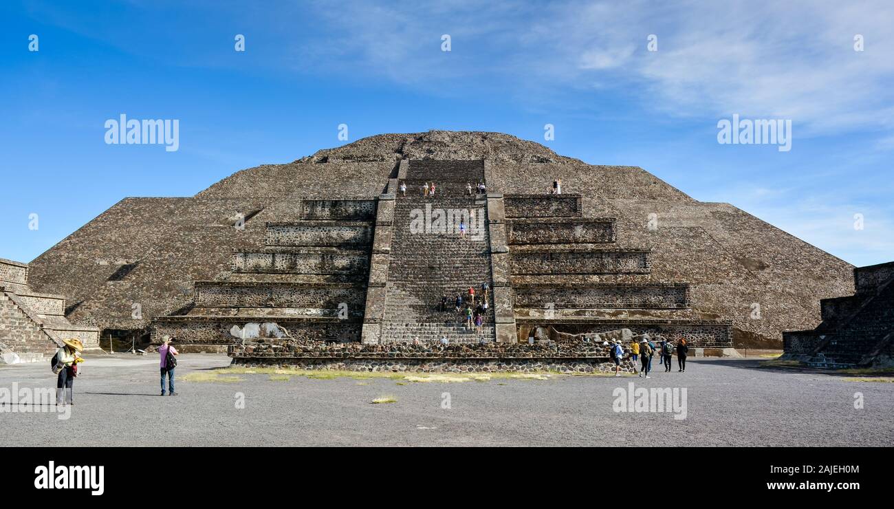 Teotihuacan, Mexico - Oct. 21, 2019: Tourists scale the Pyramid of the Moon and walk along the Avenue of the Dead. Stock Photo