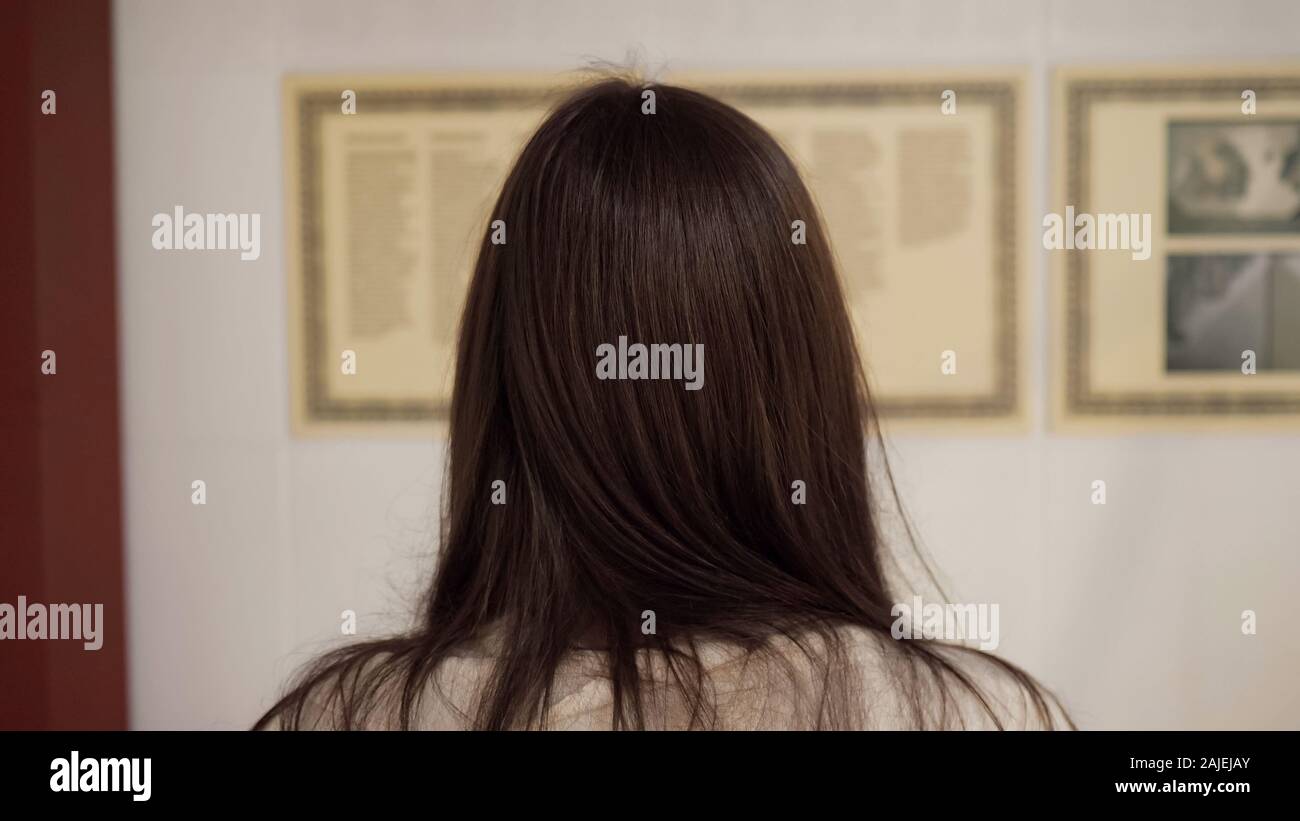 Brunette Lady With Long Hair Stands In National Art Gallery And