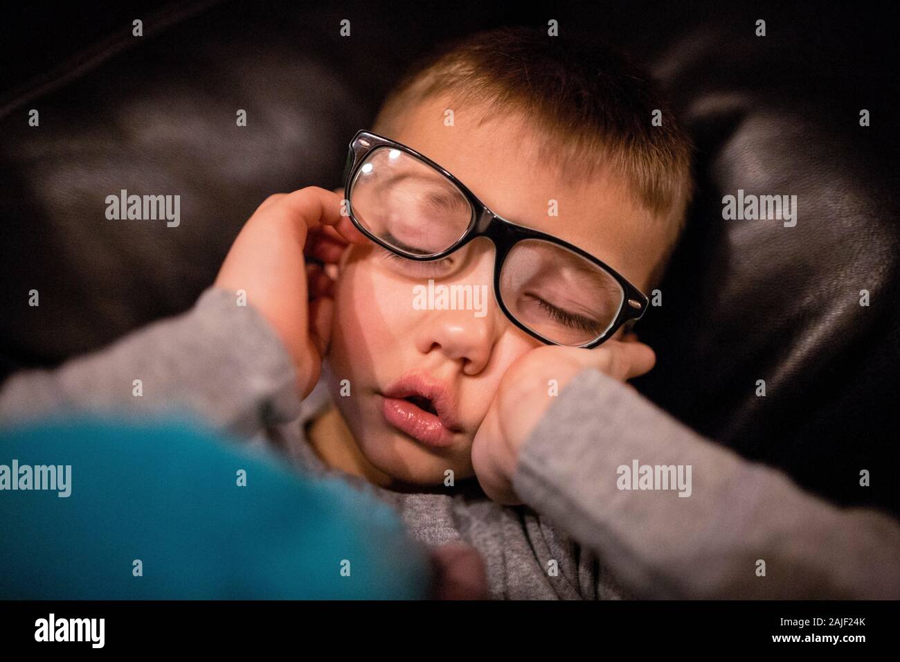 Young boy fell asleep with glasses on Stock Photo Alamy