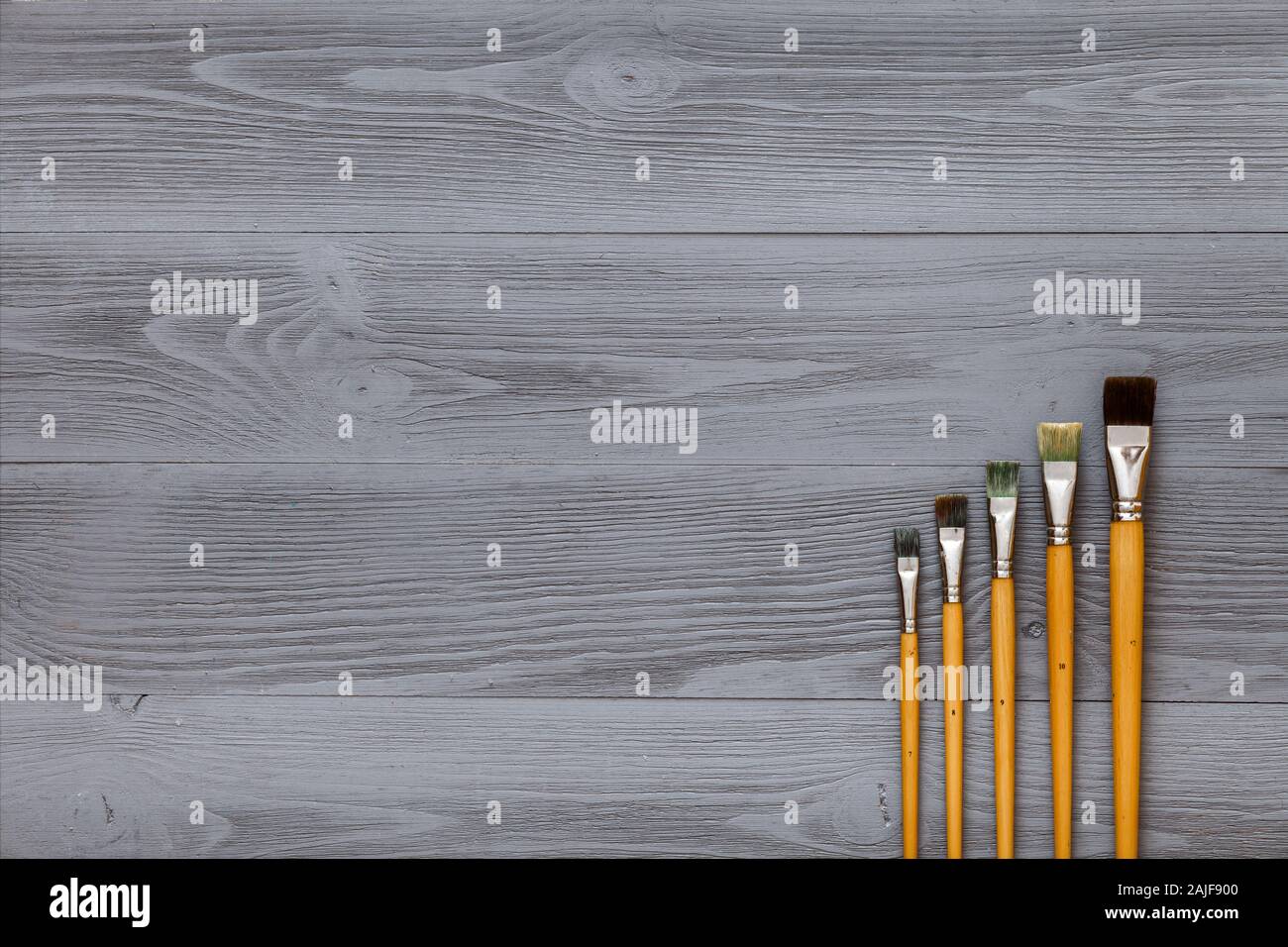 Paint brushes set on grey wooden table, artistic gray background Stock Photo