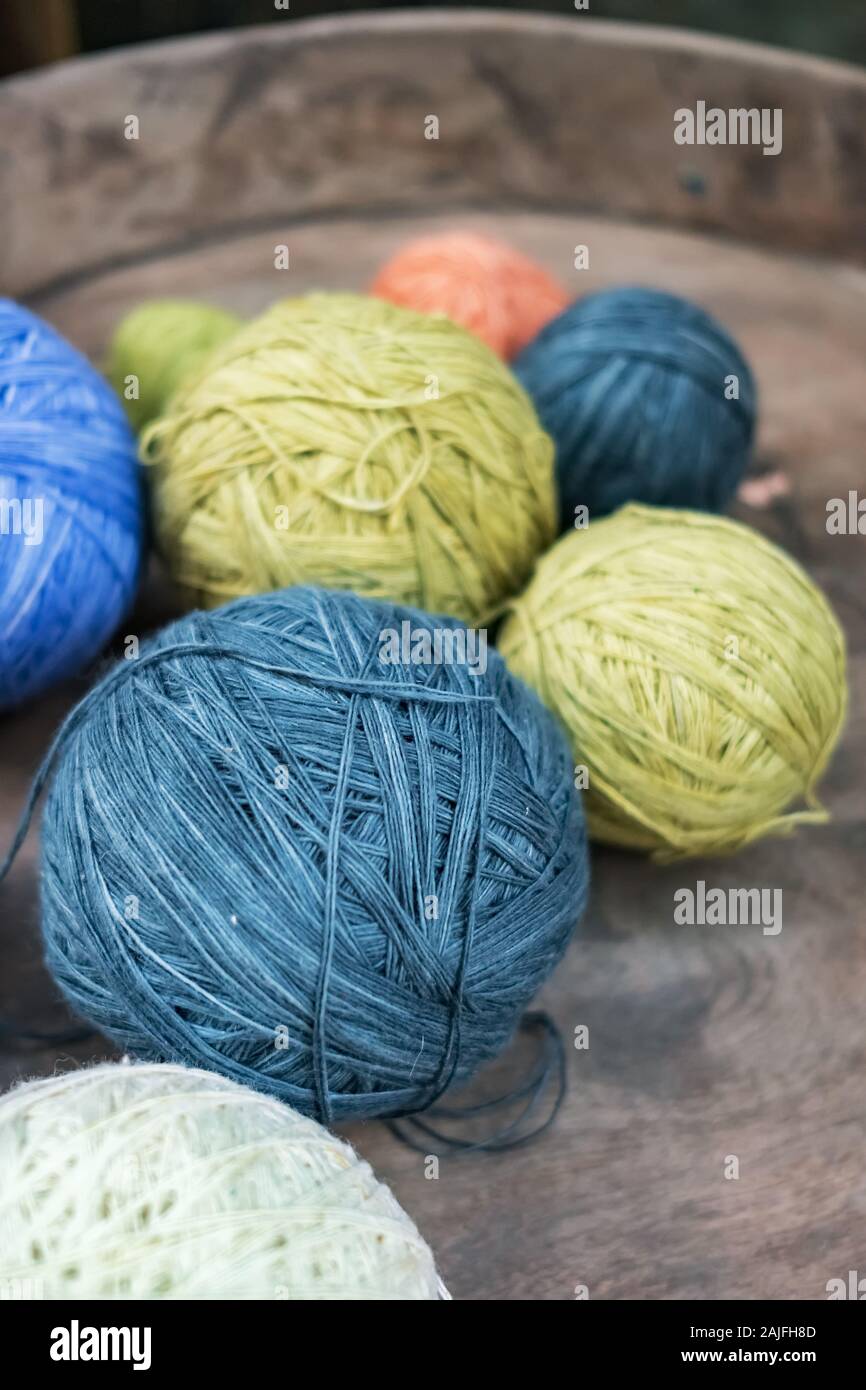 Multicolored yarn balls in a straw basket on a wooden table Stock Photo by  ©annakukhmar 40790863