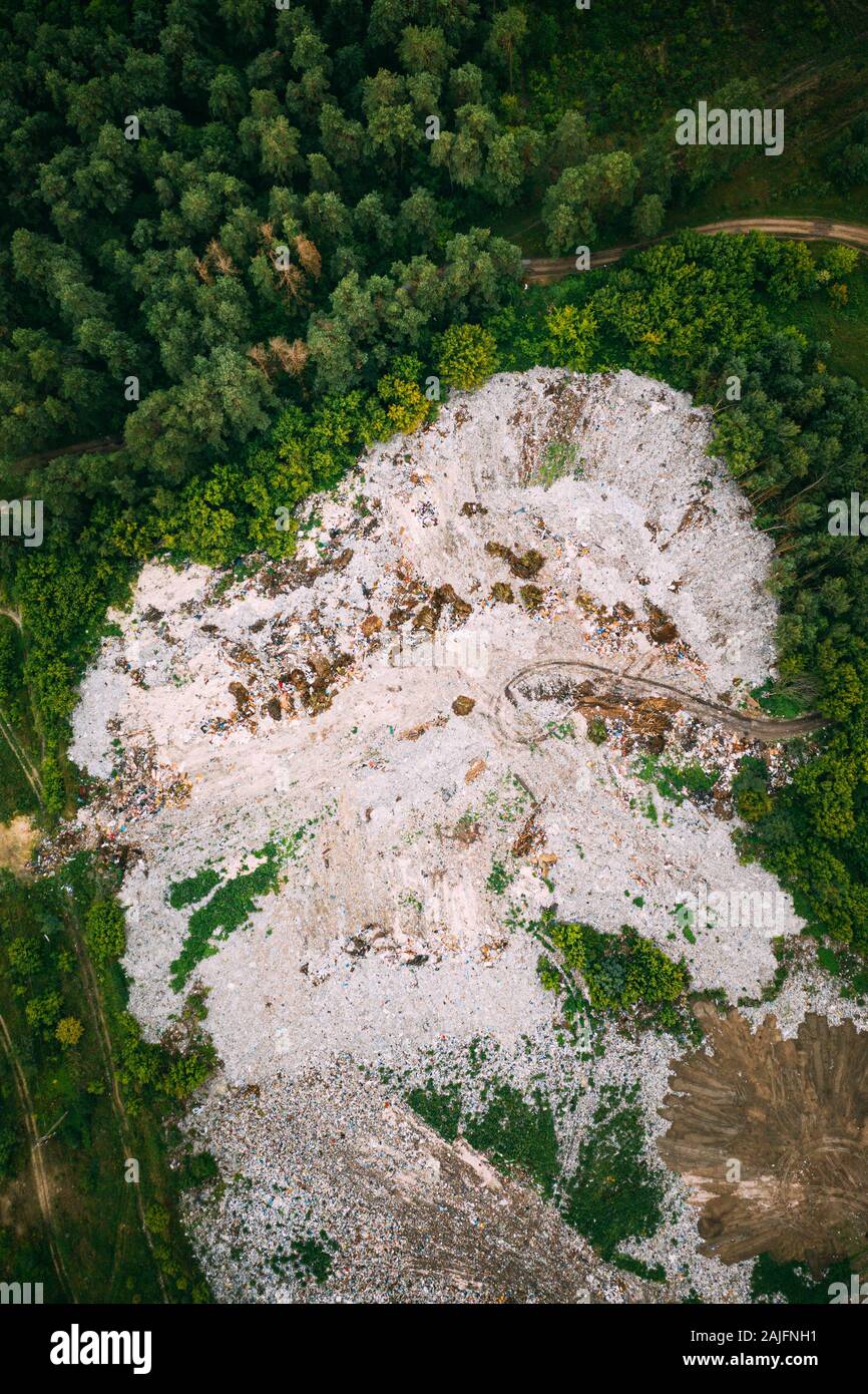 Aerial View Of Domestic Garbage Near Green Forest. Bird's-eye View Of Junk. Domestic Waste In Landfill Junkyard. Eco Concept Garbage Disaster From Eco Stock Photo