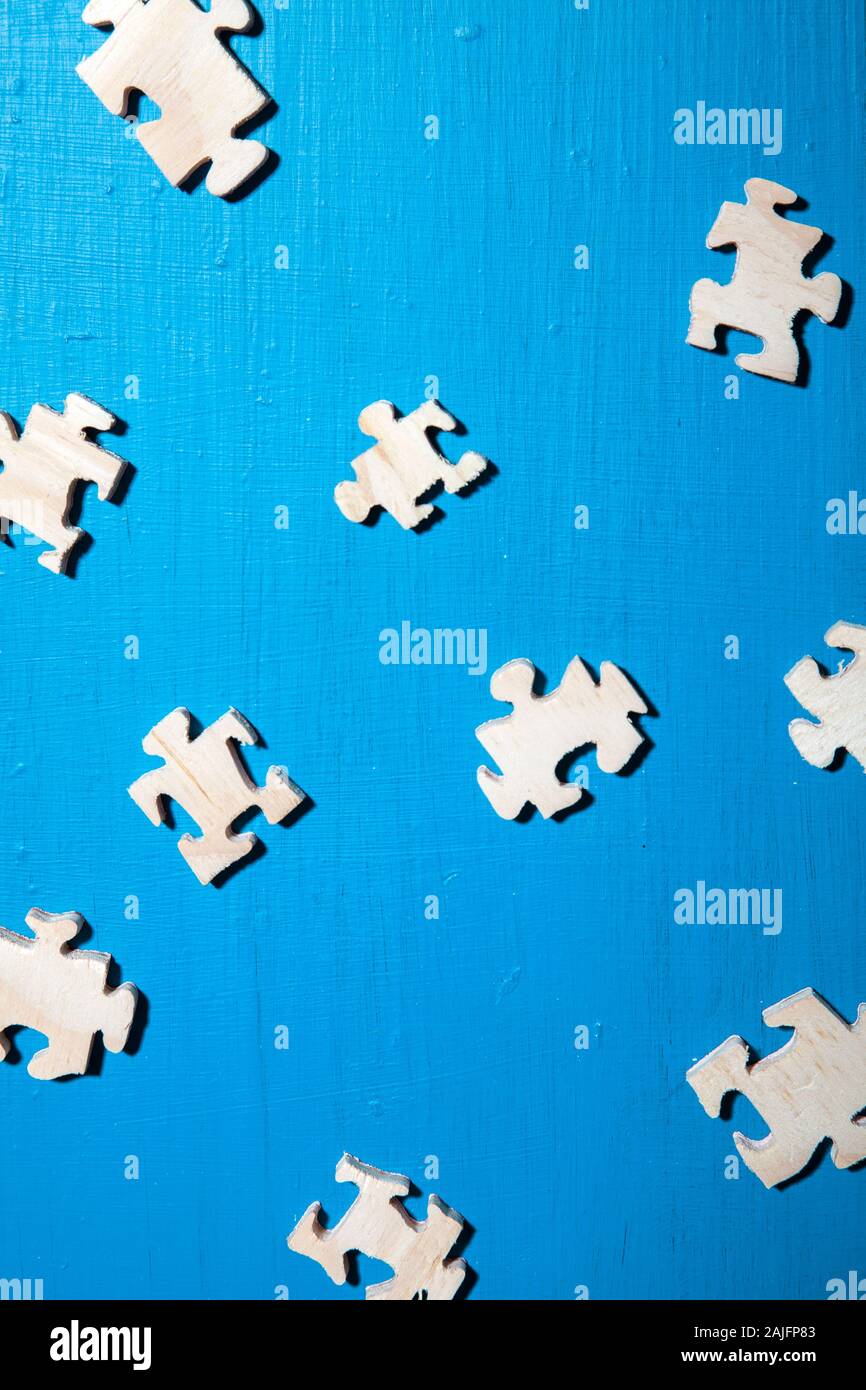 Scattered Jigsaw Pieces on Blue Surface Stock Photo