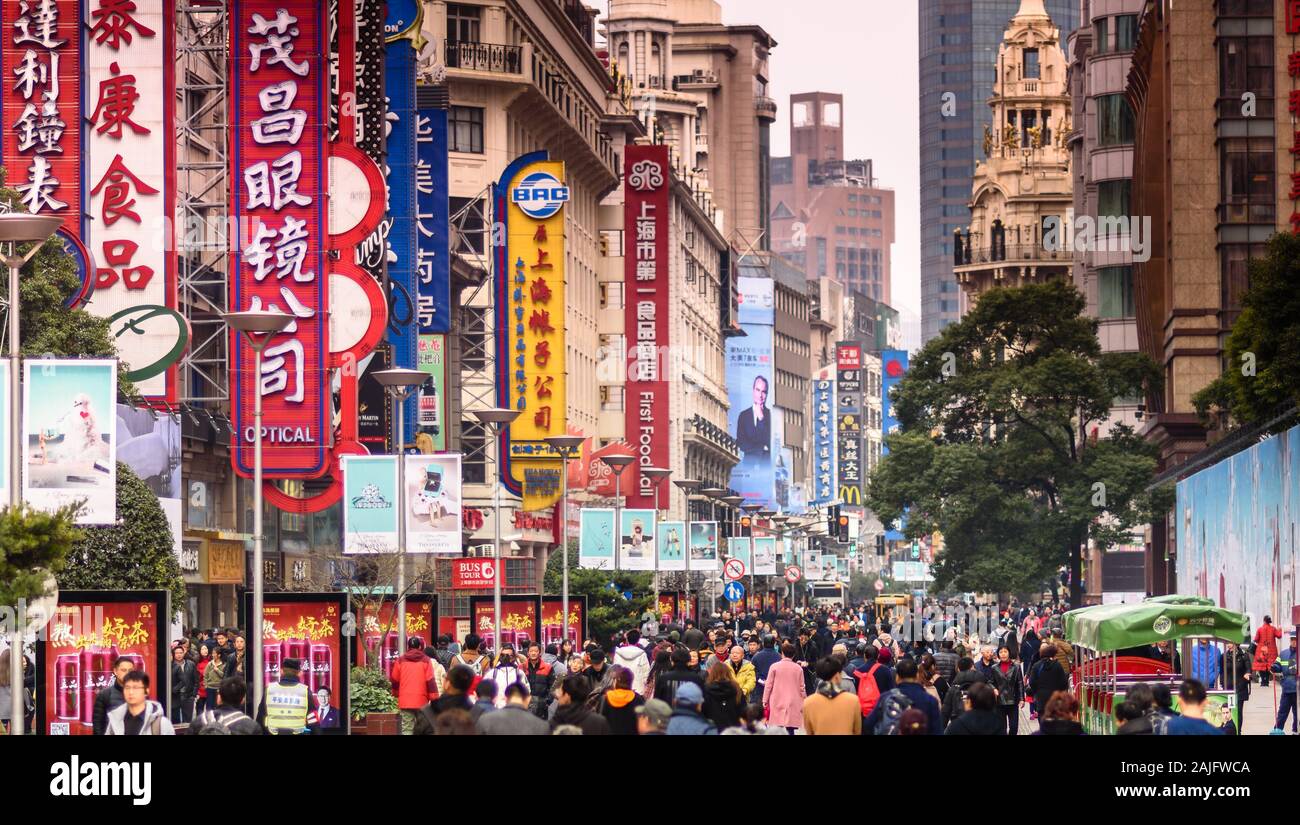 Shanghai, China: Nanjing road crowded with people, shopping street, shop signs and shop signboards. Cityscape photography, urban scene Stock Photo