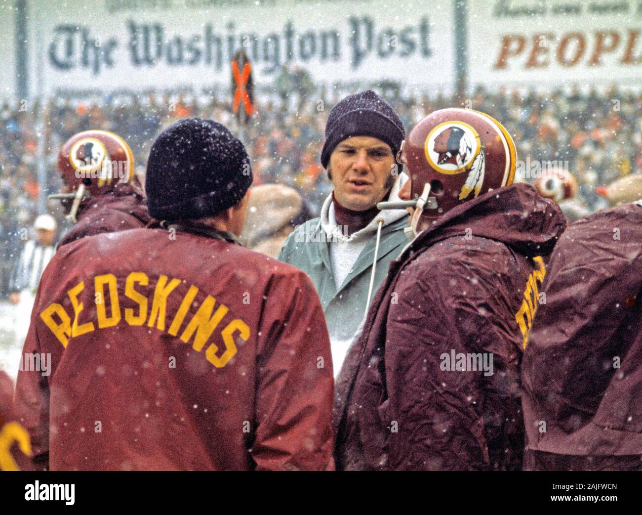 https://c8.alamy.com/comp/2AJFWCN/washington-redskins-back-up-quarterback-sam-wyche-18-center-discusses-strategy-with-fellow-quarterbacks-sonny-jurgensen-9-left-and-billy-kilmer-17-right-on-the-sidelines-during-the-game-against-the-philadelphia-eagles-at-rfk-stadium-in-washington-dc-on-sunday-december-16-1973-the-redskins-won-the-game-38-20-to-end-their-regular-season-with-ten-wins-and-four-losses-to-qualify-for-the-nfc-play-offscredit-arnie-sachscnp-usage-worldwide-2AJFWCN.jpg
