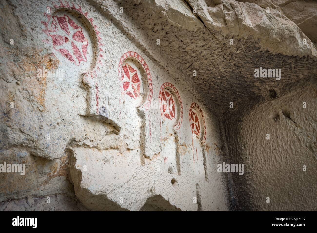 A row of Maltese crosses decorating the wall of an early Christian church in Goreme Open Air Museum (UNESCO heritage site) in Cappadocia, Turkey Stock Photo