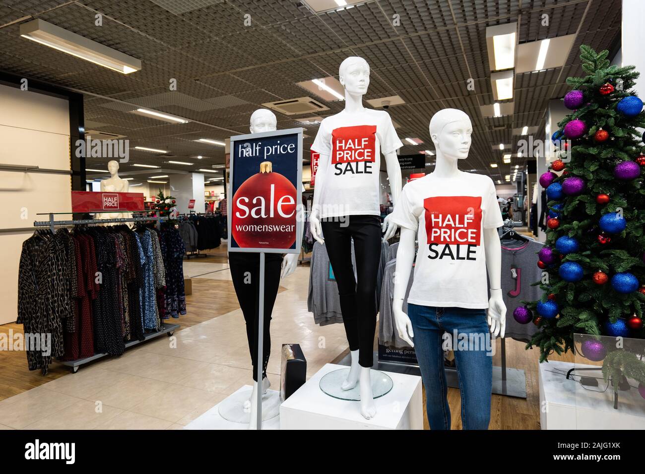 Mannequin's in the Debenhams department store, clothing shop advertising a  half price sale, post Christmas and New Year sales Stock Photo - Alamy
