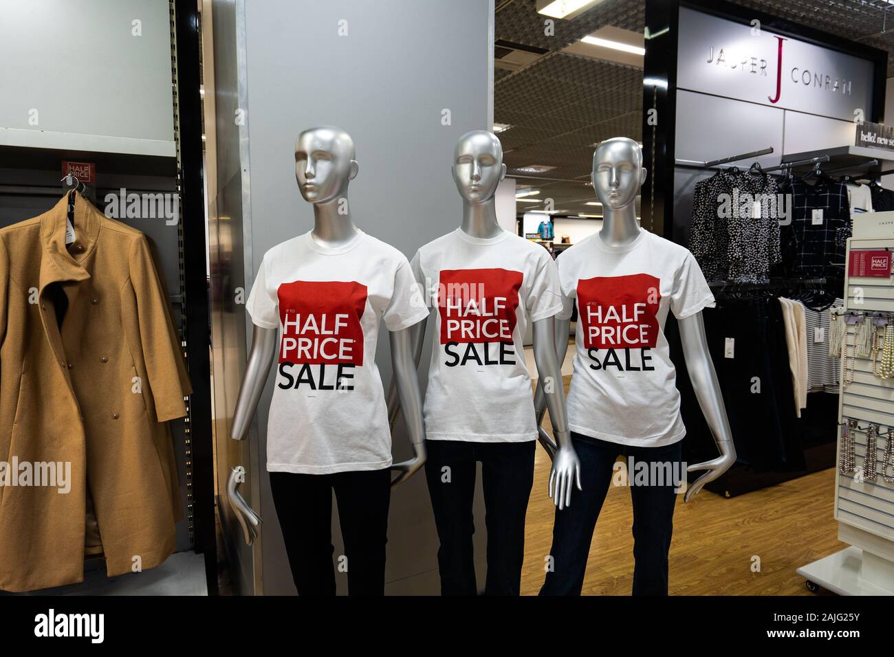 Mannequin's in the Debenhams department store, clothing shop advertising a  half price sale, post Christmas and New Year sales Stock Photo - Alamy