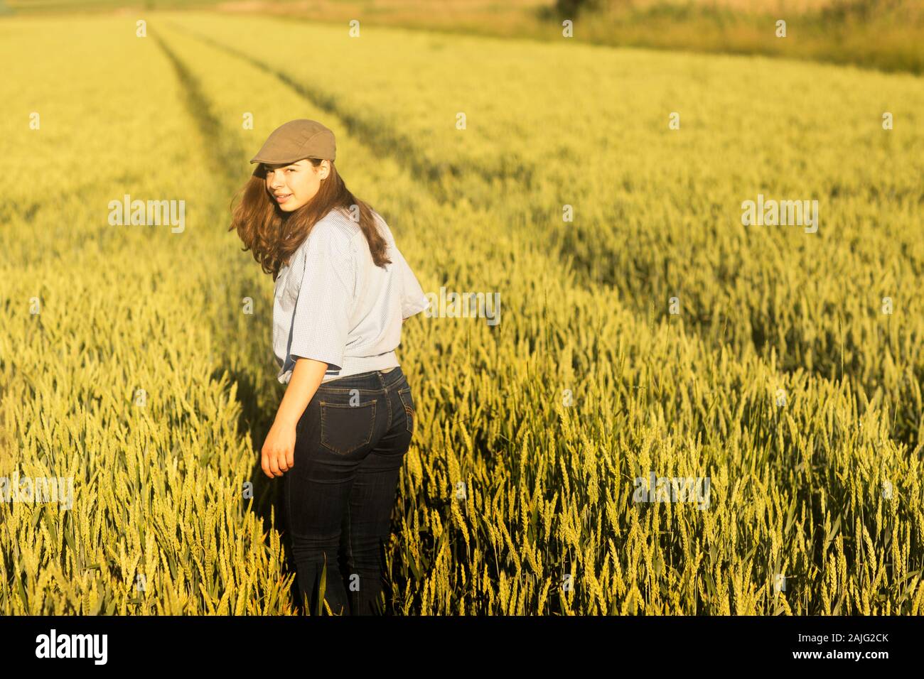 Woman walking through a wheat field hi-res stock photography and images ...