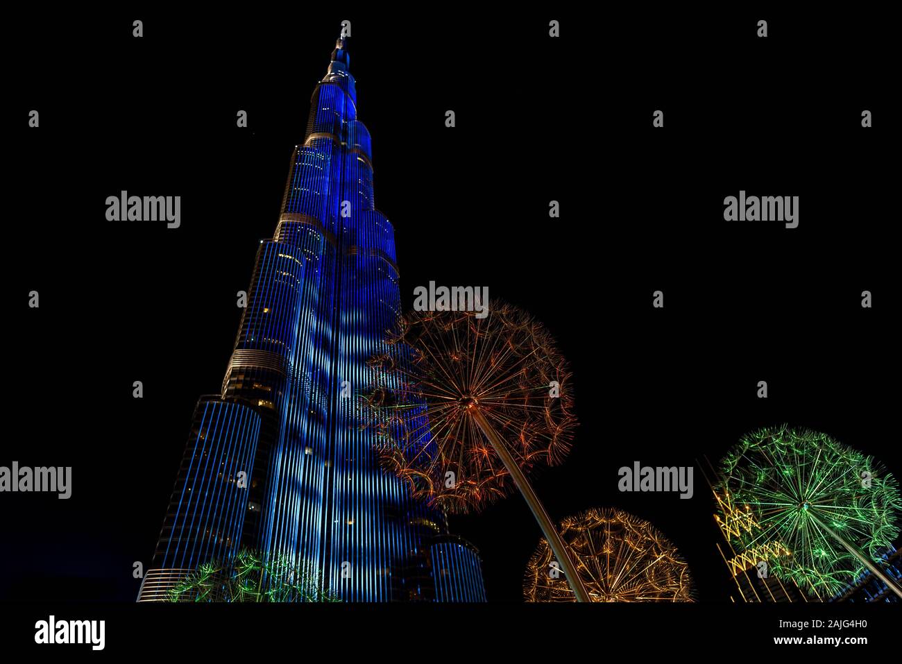 Dubai, United Arab Emirates: futuristic light show on Burj Khalifa, tallest building skyscraper in the world, by night, illuminated, from ground level Stock Photo