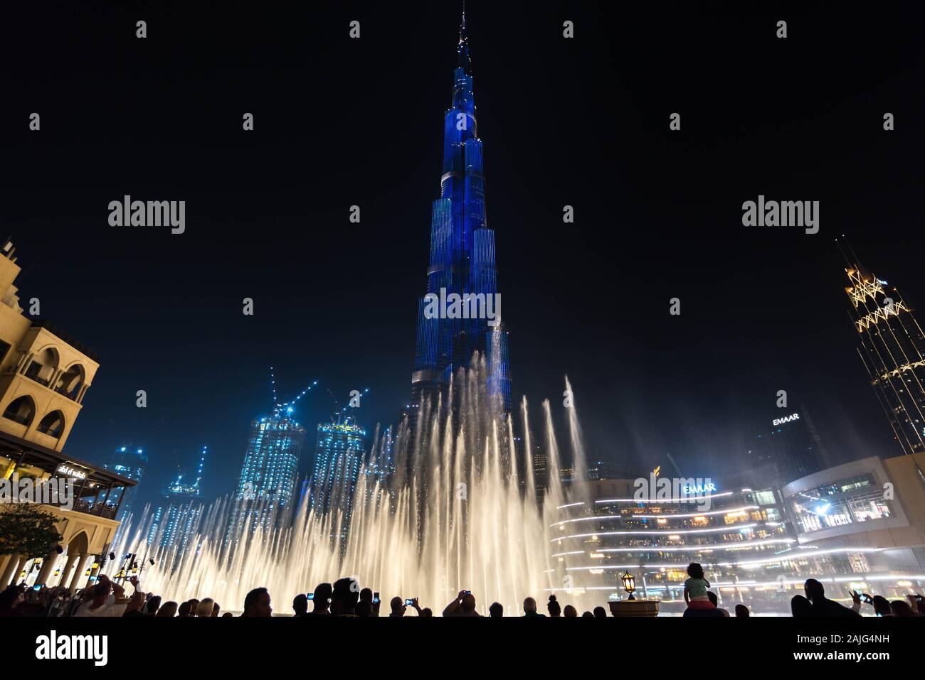 Dubai, United Arab Emirates: Amazing light and fountains show on the Burj Khalifa, the tallest building skyscraper in the world, illuminated by night Stock Photo
