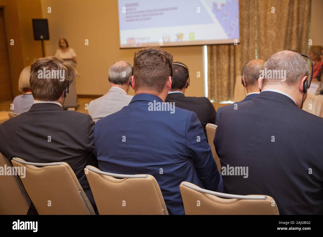 Unrecognizable man using headphones for translation during video