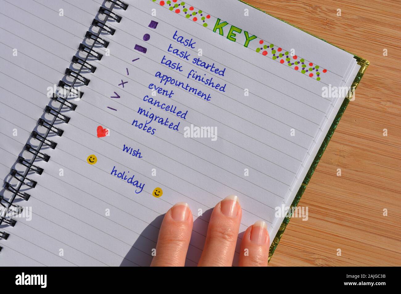Bullet journal and woman's hand Stock Photo