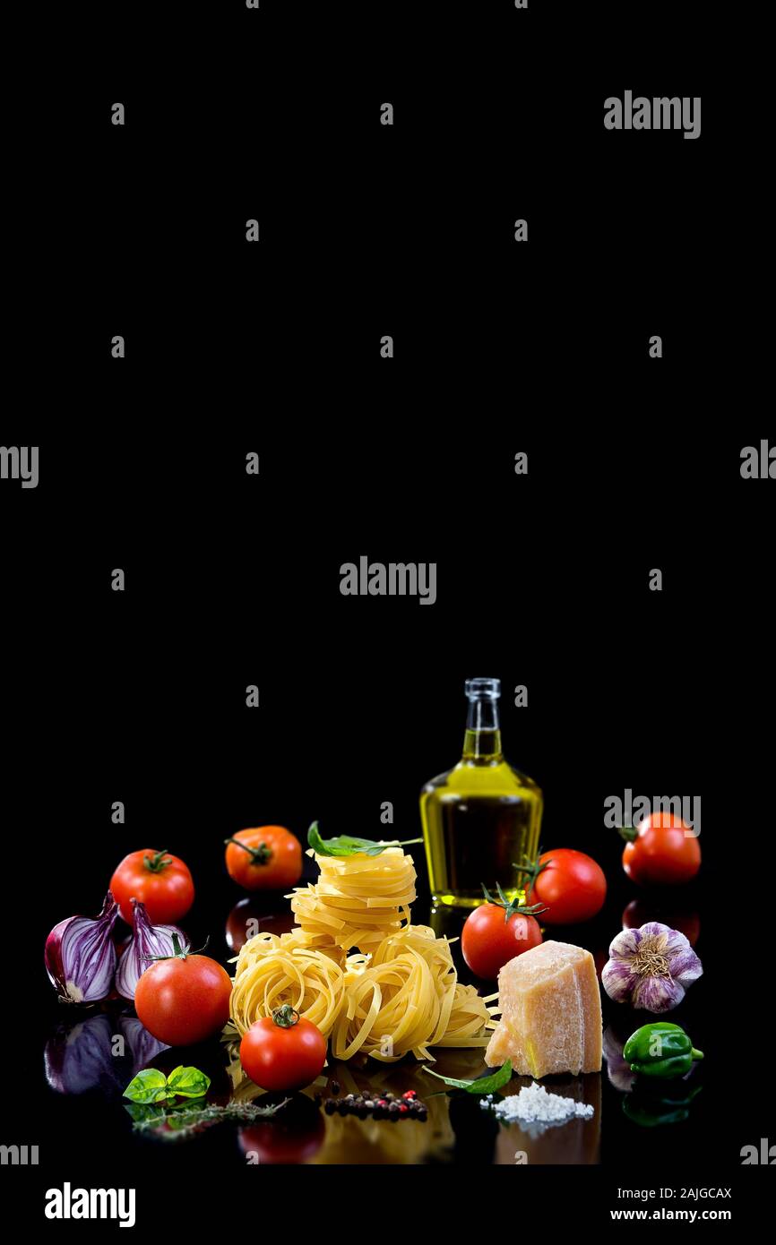 The composition of the pasta and vegetables on black background Stock Photo