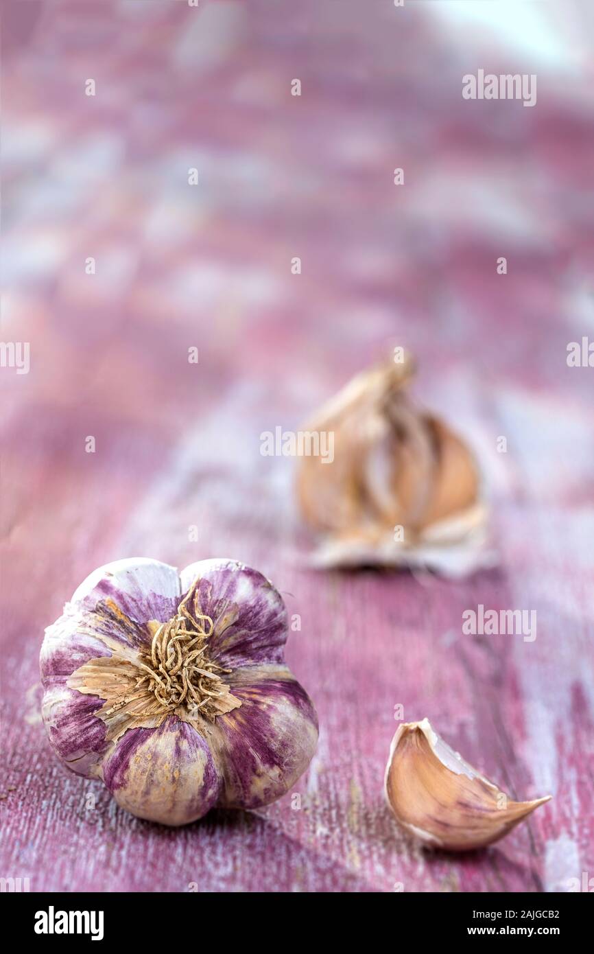 New harvest french big pink and violet garlic braid from france on pink wooden, background Stock Photo