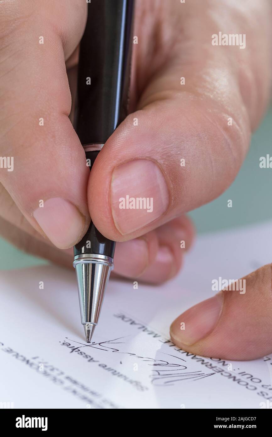 Doctor signing prescription on the prescription sheet Stock Photo